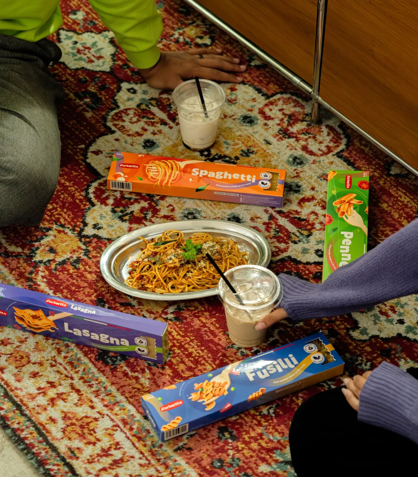 Forketta Spaghetti, Penne, Lasagna and Fusilli boxes styled on a rug with a plated dish